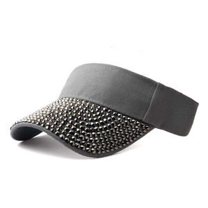 Detail of grey sun visor hat with rhinestone studs and cotton twill texture