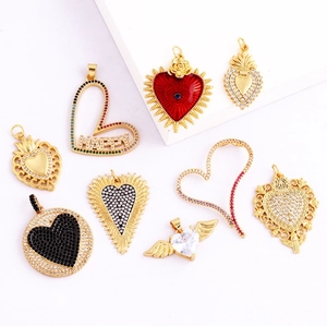 Macro view of gold plated heart charms featuring zircon inlays and colorful enamel details