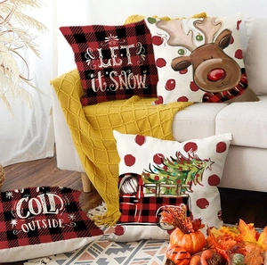 Close-up of Christmas pillow covers with reindeer and let it snow holiday prints