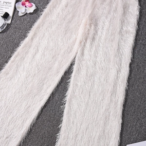 Gros plan du tissu pelucheux doux sur ce pantalon court évasé de couleur blanc crème
