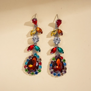 Macro view of teardrop earrings with colorful zircon leaf accents and crystal stones
