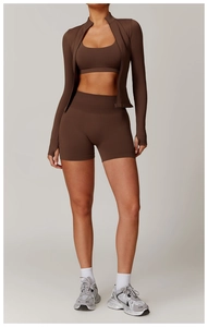 Three-piece chocolate brown yoga set including slim zip jacket, bra, and biker shorts