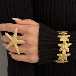 Golden stainless steel starfish open ring and bangle set on female model with black sweater