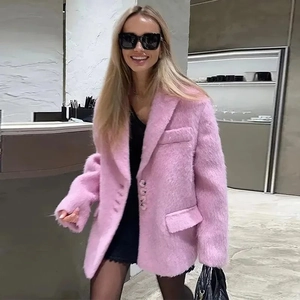Detailed view of plush pink faux fur blazer jacket with fluffy texture and lapel design