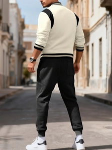 Back view of a casual two-piece baseball set featuring a white jacket and black joggers