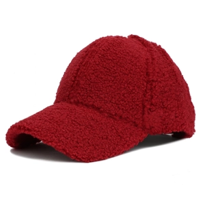 Close-up of soft red sherpa fleece baseball cap showing textured warm fabric detail