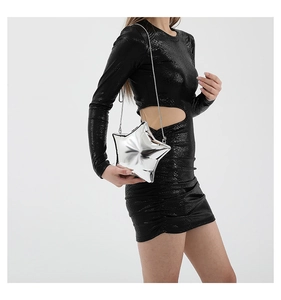 Detail of silver mirror star-shaped crossbody bag with a slim metallic chain strap