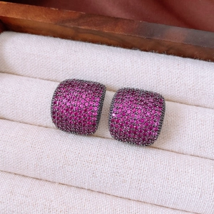 Macro shot of vintage rose red zircon square stud earrings in a luxury jewelry box