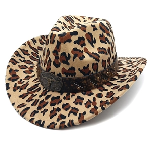 Close-up of leopard print cowboy hat featuring a vintage bull head metal buckle and stud band