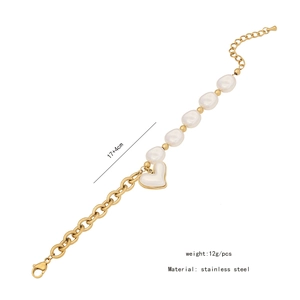 Detail shot of stainless steel gold chain with white pearl and heart pendant charm