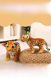 Close-up of leopard plush dolls in two sizes featuring spotted fur and bright eyes