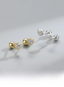 Macro detail of S925 sterling silver heart studs with cubic zirconia and screw back