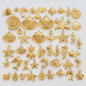 Golden stainless steel ocean theme charms including shells, starfish and dolphins pendants