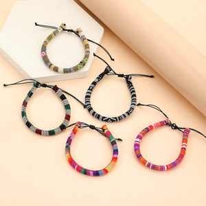 Detail of five bohemian hand-woven friendship bracelets with adjustable knots
