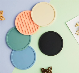 Close-up of thick 10cm silicone coasters in various colors with drainage and non-slip textures