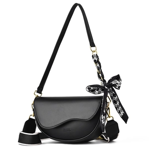Classic black leather saddle bag with gold hardware and checkered scarf on white background