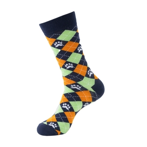 Macro detail of argyle pattern socks with green and orange knit and dog paw print