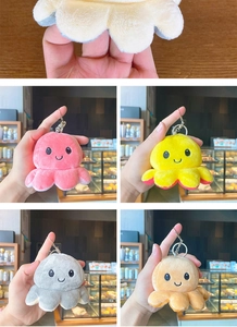 Detail of colorful reversible octopus plush keychains in pink, yellow, grey and orange
