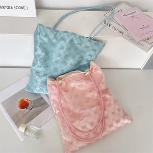 Detailed texture of quilted tote bags with bow accents in blue and pink pastel colors