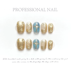 Handmade starry blue and gold press-on nail set with glitter, pearls and star charms