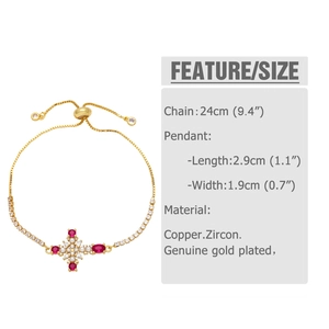 Detail view of golden adjustable bracelet with zircon cross pendant and red gemstone inlay