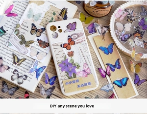 Detailed view of translucent butterfly stickers decorating a vintage phone case and bookmarks