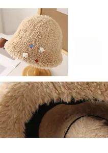 Detail of plush beige bucket hat with soft faux fur texture and cute bear ornaments