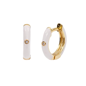 Macro detail of white enamel earrings with gold plating and sparkling crystal stud