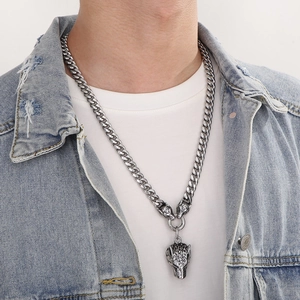 Men's stainless steel Cuban chain necklace featuring a wolf head pendant on a male model