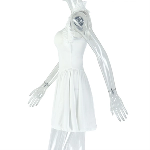 Detail of white backless pleated A-line dress with tiered ruffle layers on a mannequin