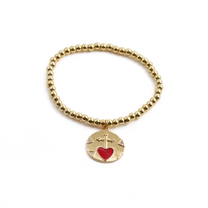 Gold beaded bracelet featuring red enamel heart charm with a cross and cubic zirconia