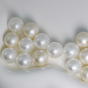 White round ABS faux pearls with wrinkled matte texture and holes for jewelry making