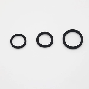 Macro detail of high-elasticity black seamless hair ties in three different diameter sizes