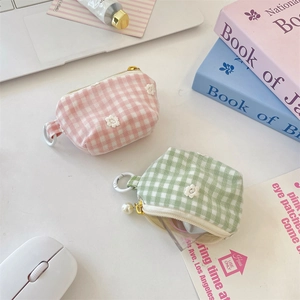 Detailed view of plaid mini coin purses with daisy embroidery and pearl zipper charms