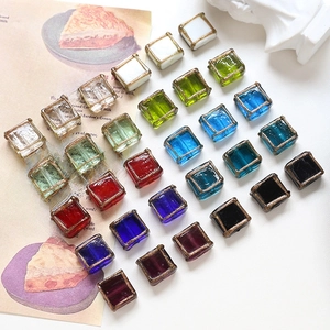 Close-up of square vintage crystal glass beads with gold foil trim for DIY jewelry