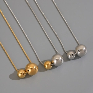 Three minimalist titanium steel snake chains with dual spheres in gold and silver finishes