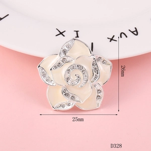 Macro detail of camellia charm with silver edges and crystals for DIY phone cases