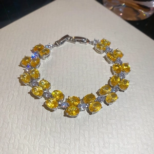 Detailed shot of double layer silver bracelet with oval yellow zircon and folding clasp