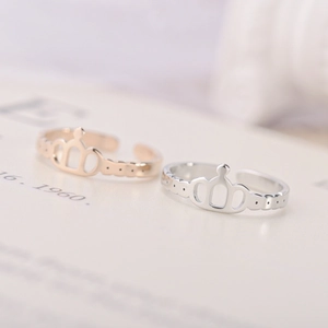 Detailed close-up of adjustable crown rings in gold and silver stainless steel finish