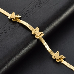 Golden snake chain necklace with three 3D butterfly charms on a black leather backdrop