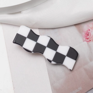 Checkerboard pattern wavy hair clip on white silk background for women hair styling