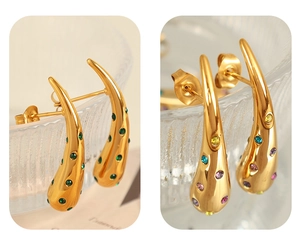 Macro detail of 18K gold plated teardrop earrings with green and multicolor zircon stones