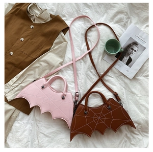 Pink and brown bat-shaped PU bags with spiderweb stitching and removable straps