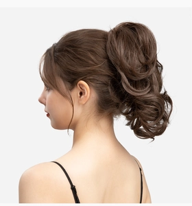 Detail view of wavy brown ponytail hair extension with claw clip for natural volume