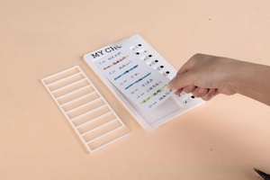 Close-up of sliding mechanism on white plastic kids' chore chart with replaceable lists