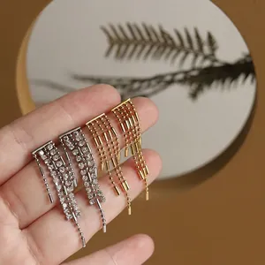 Elegant gold and silver tassel earrings with crystal chains and tiered metallic fringe