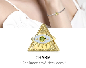 Macro detail of gold pyramid evil eye charm for necklaces and bracelets