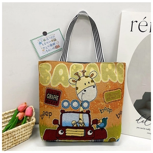 Detail view of woven tote bag with cartoon giraffe print and striped handles