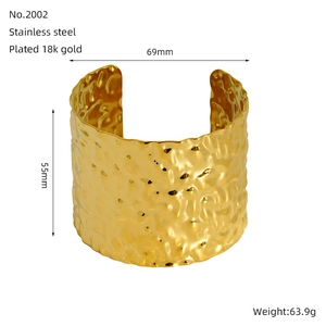 Detail view of 18K gold plated stainless steel wide cuff bracelet with hammered texture