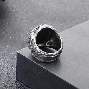 Detailed macro view of vintage stainless steel eagle ring with black stone inlay